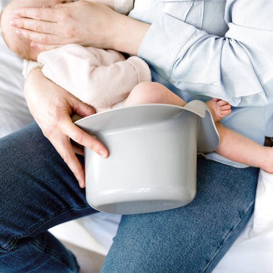 Stopper cup in arm with baby.