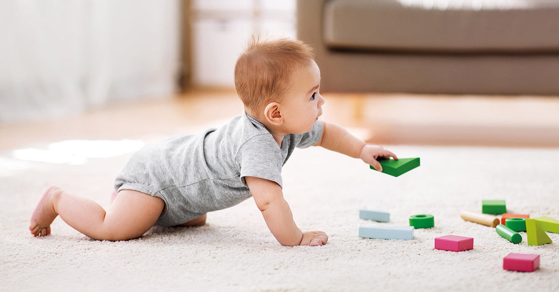Baby plays with sustainable wooden toy.