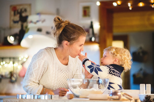 child preparing the Christmas meal with his mother