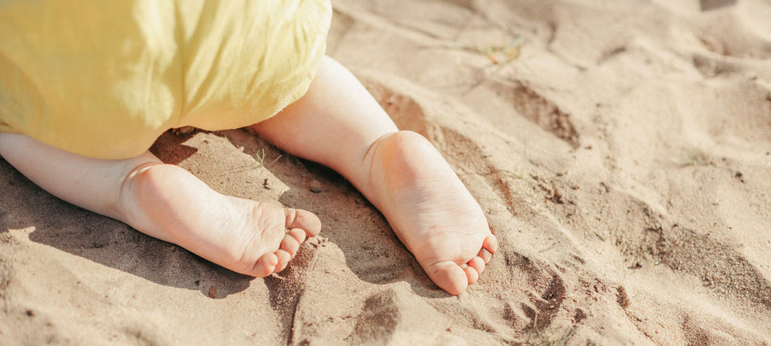 Baby crawls in the sand