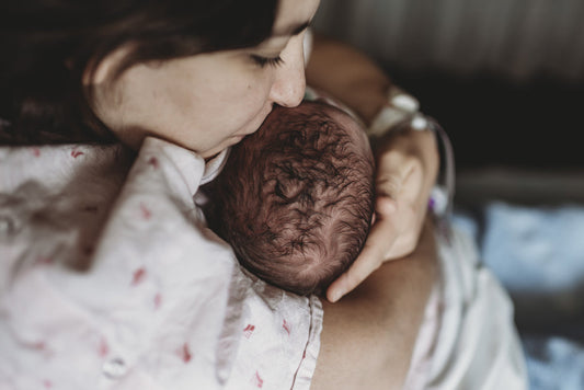 newborn and his mother after a natural childbirth