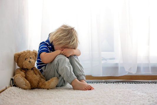 Little child crying on the ground