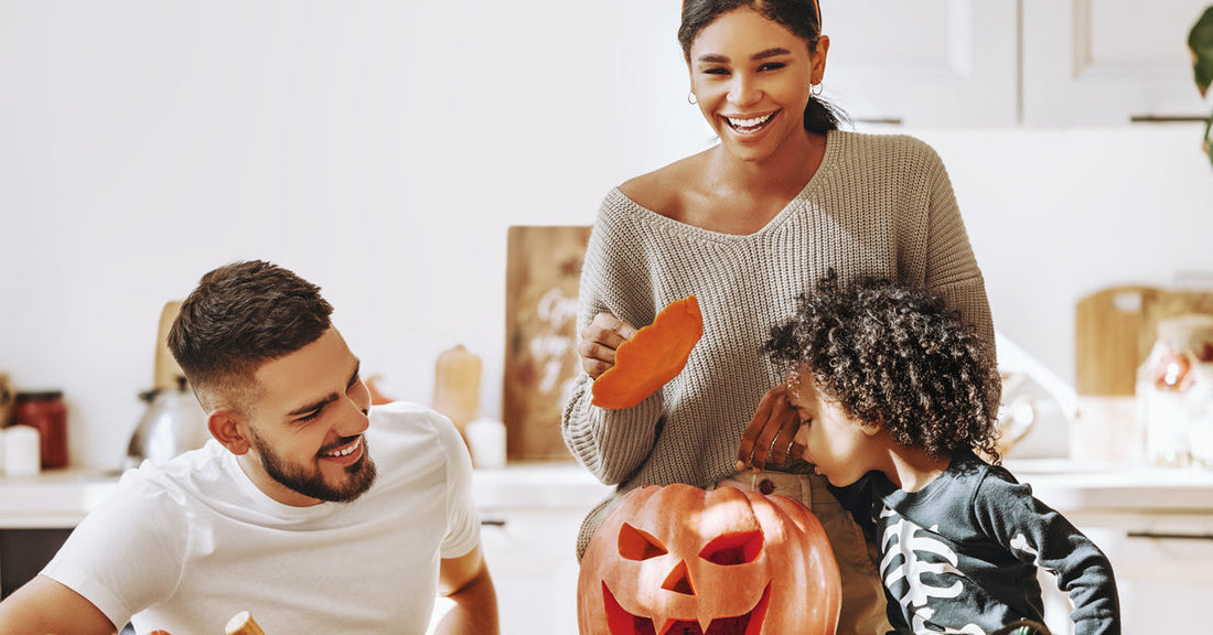 Family celebrates Halloween with a pumpkin.
