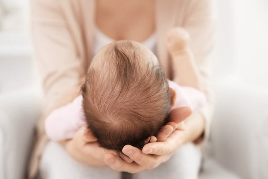 mother holding her baby's head