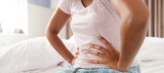 Woman with menstrual pain supporting her hands on her hips