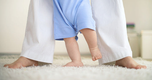 Baby walking with her mother