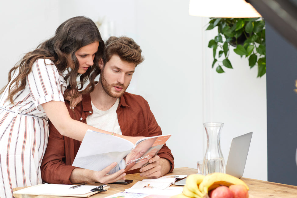 Man and woman reading a magazine