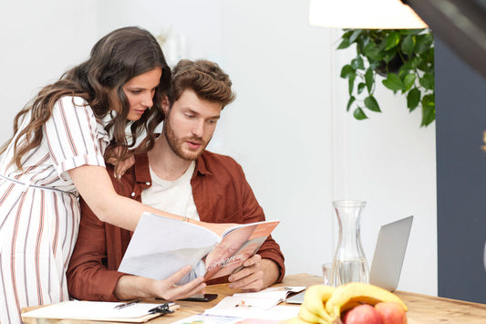 Man and woman reading a magazine