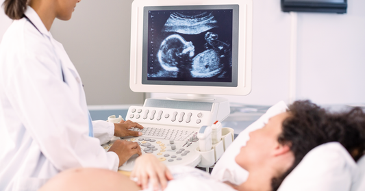 Pregnant woman examined by her gynecologist via ultrasound