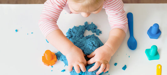 little girl playing with modeling clay