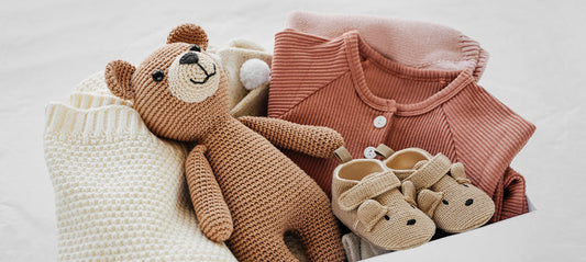 Birth gifts: teddy bear, baby clothes, baby slippers