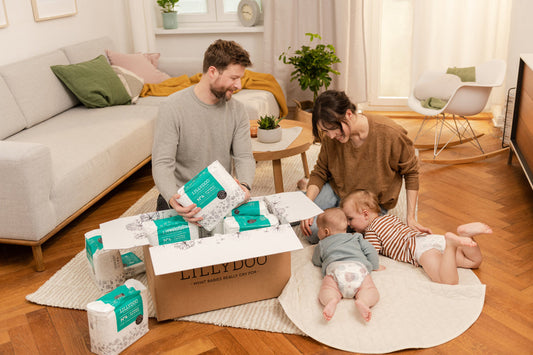 Parents unpack the subscription box together alongside two babies