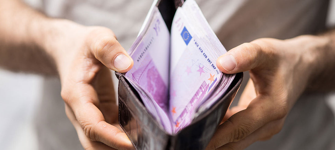 Open wallet full of purple bills.