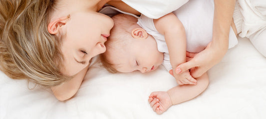 Mom lying on the bed with her baby