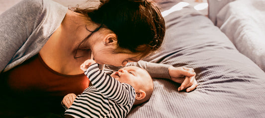 Mother and baby lying on the bed