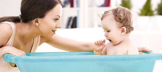 child in his bathtub taking a bath