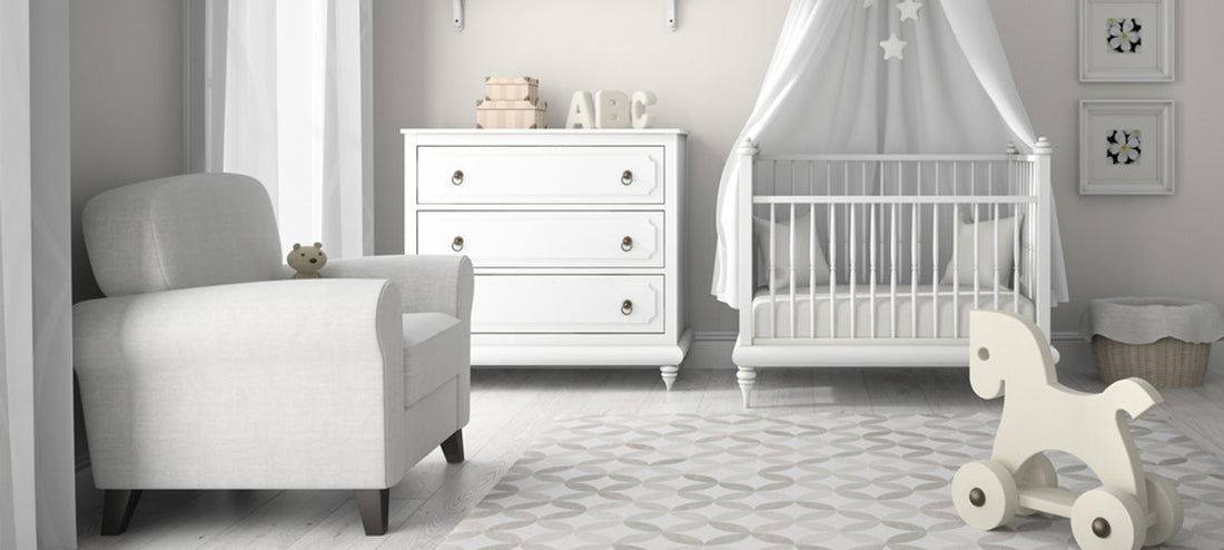 Baby room in white with baby bed, armchair, dresser, and rocking horse.
