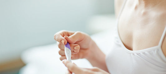 woman holding a pregnancy test in her hands