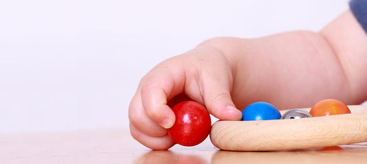 young child practicing their motor skills with a toy