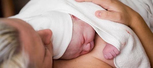 Mom holding the baby skin-to-skin after birth