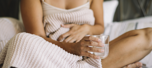 woman sitting on the sofa with a glass of water
