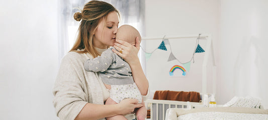 Mom holding her baby in a diaper